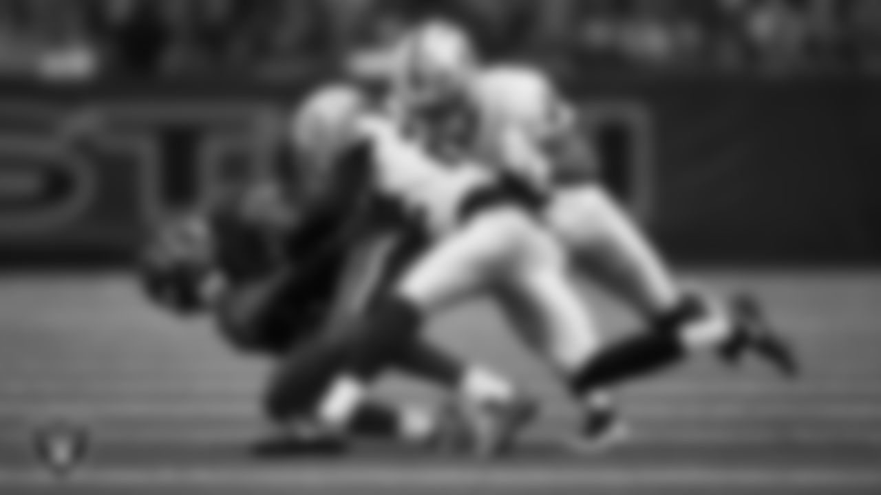 Las Vegas Raiders cornerback Eric Stokes (22) and safety Jeremy Chinn (11) make a tackle during the regular season away game against the Houston Texans at NRG Stadium.