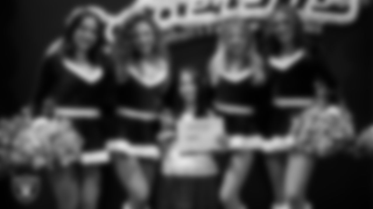 Raiderettes pose for a photo with a Junior Raiderette during the Junior Raiderettes Banquet at The Studio.