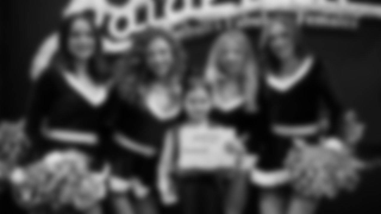 Raiderettes pose for a photo with a Junior Raiderette during the Junior Raiderettes Banquet at The Studio.