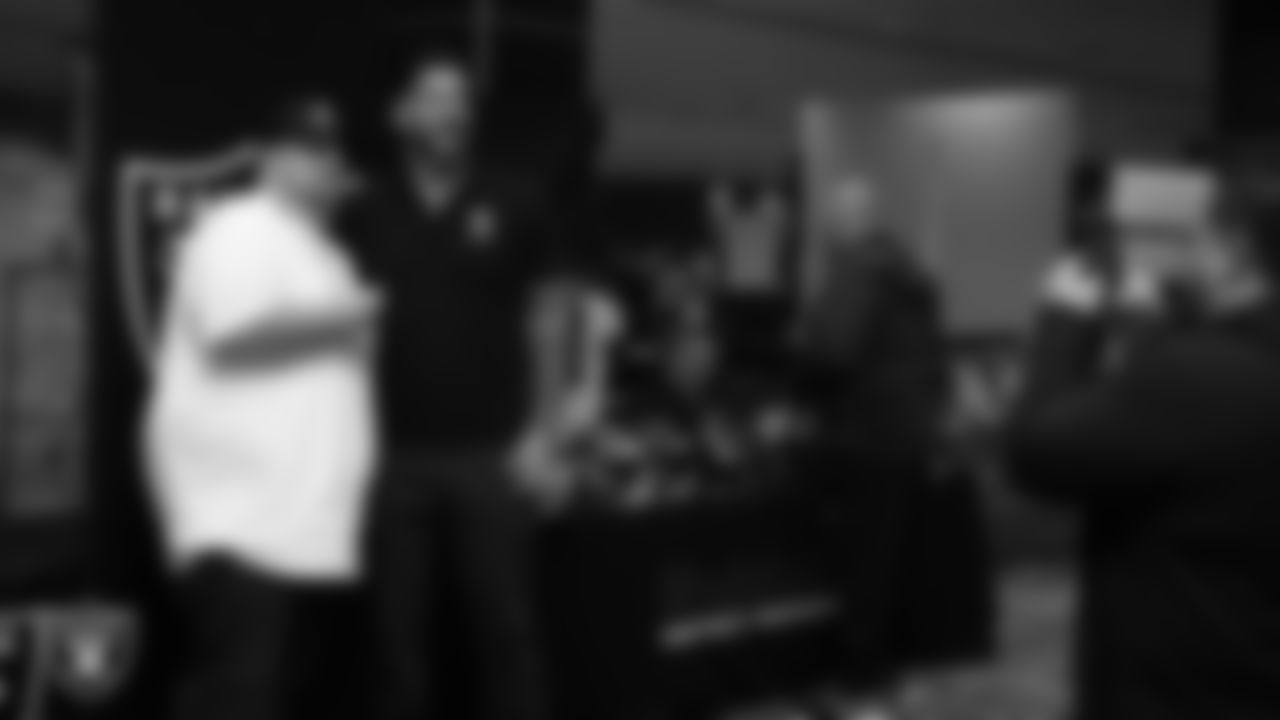 Las Vegas Raiders alumnus Robert Gallery poses for a photo with a high school football coach during a Glazier Clinic at Grand Sierra Resort.