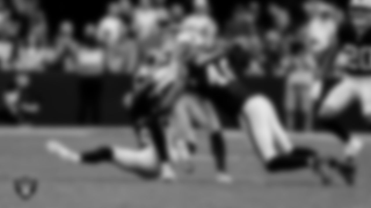Las Vegas Raiders cornerback Darien Porter (26) and defensive end Charles Snowden (49) during the regular season home game against the Denver Broncos at Allegiant Stadium.