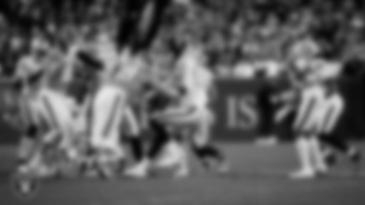Las Vegas Raiders defensive end Maxx Crosby (98) makes a tackle during the regular season away game against the Denver Broncos at Empower Field at Mile High.