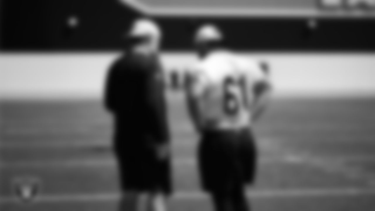 Las Vegas Raiders run game coordinator/offensive line coach Brennan Carroll and offensive lineman Jordan Meredith (61) at a workout during phase two of the offseason program at Intermountain Health Performance Center.