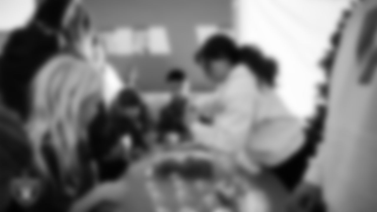 Children decorate ornaments during the Raiders Holiday Salute at Nellis Air Force Base - Coral Academy.