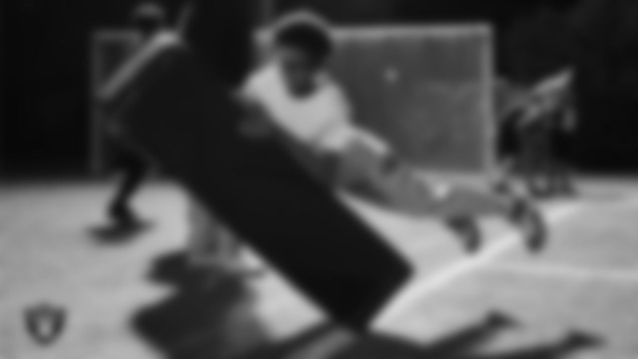 An athlete takes part in a Silver and Black League flag football clinic at Bill and Lillie Heinrich YMCA.