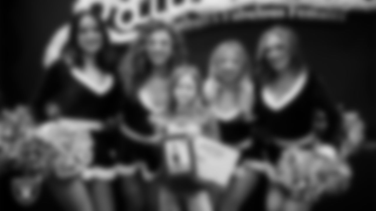 Raiderettes pose for a photo with a Junior Raiderette during the Junior Raiderettes Banquet at The Studio.