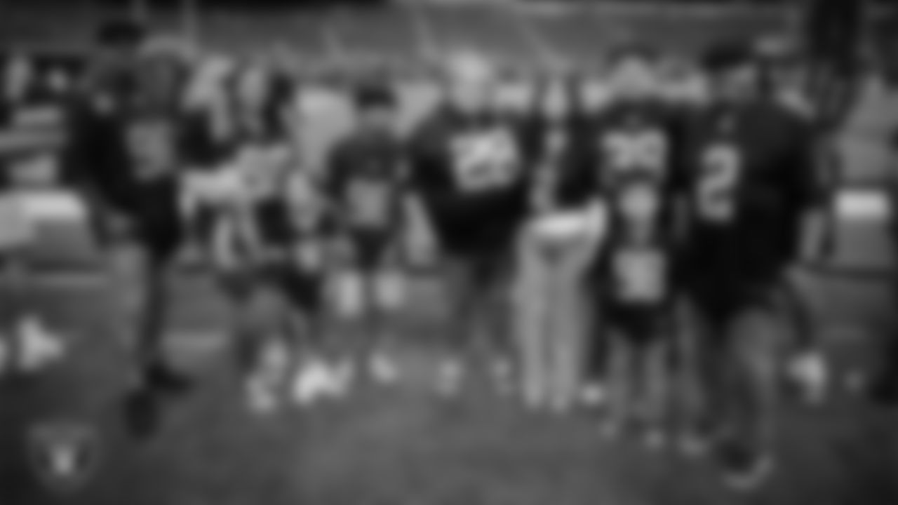 Christopher Arias and Marcos Carrillo and their families from Make-A-Wish on the sidelines before the Las Vegas Raiders' regular season home game against the Jacksonville Jaguars at Allegiant Stadium.