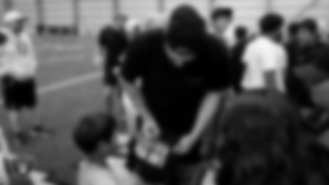 Las Vegas Raiders defensive end Maxx Crosby (98) signs autographs for members of the Shoshone Paiute Tribe during their visit to Intermountain Health Performance Center.