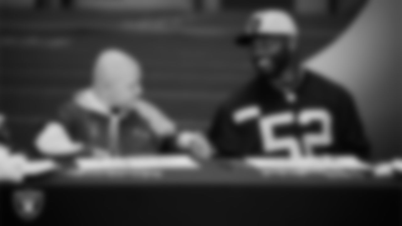 Las Vegas Raiders linebacker Elandon Roberts (52) designs cleats for My Cause My Cleats with Intermountain Children's Health patient Isaak at Intermountain Health Performance Center.