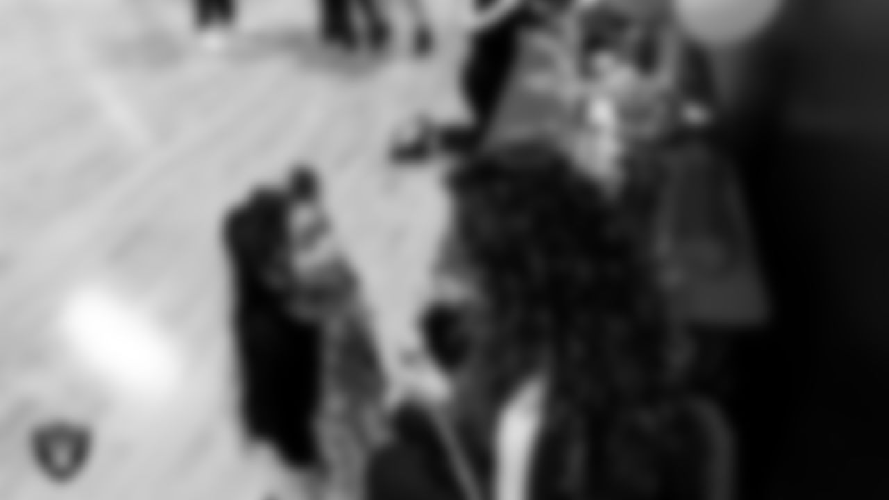 Raiderette Lexie does an attendee's makeup during the Valentine's Day Dance at The Studio.