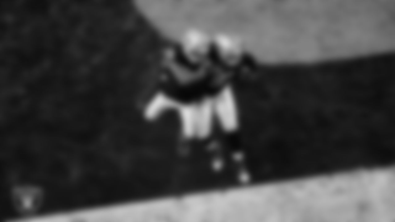 Las Vegas Raiders defensive tackle Tonka Hemingway (97) celebrates with defensive end Charles Snowden (49) after recovering a fumble during the regular season home game against the Dallas Cowboys at Allegiant Stadium.