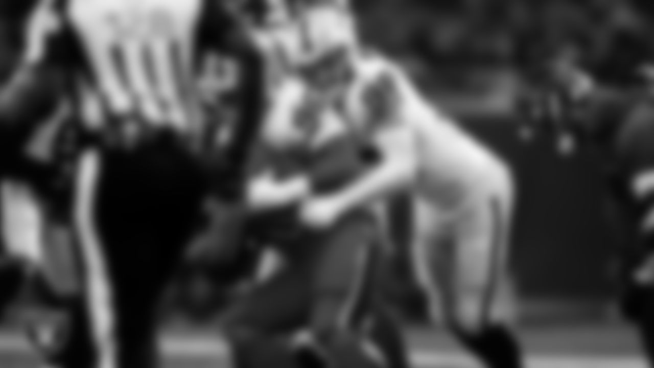 Las Vegas Raiders defensive tackle Jonah Laulu (96) and defensive end Maxx Crosby (98) make a tackle during the regular season away game against the Houston Texans at NRG Stadium.