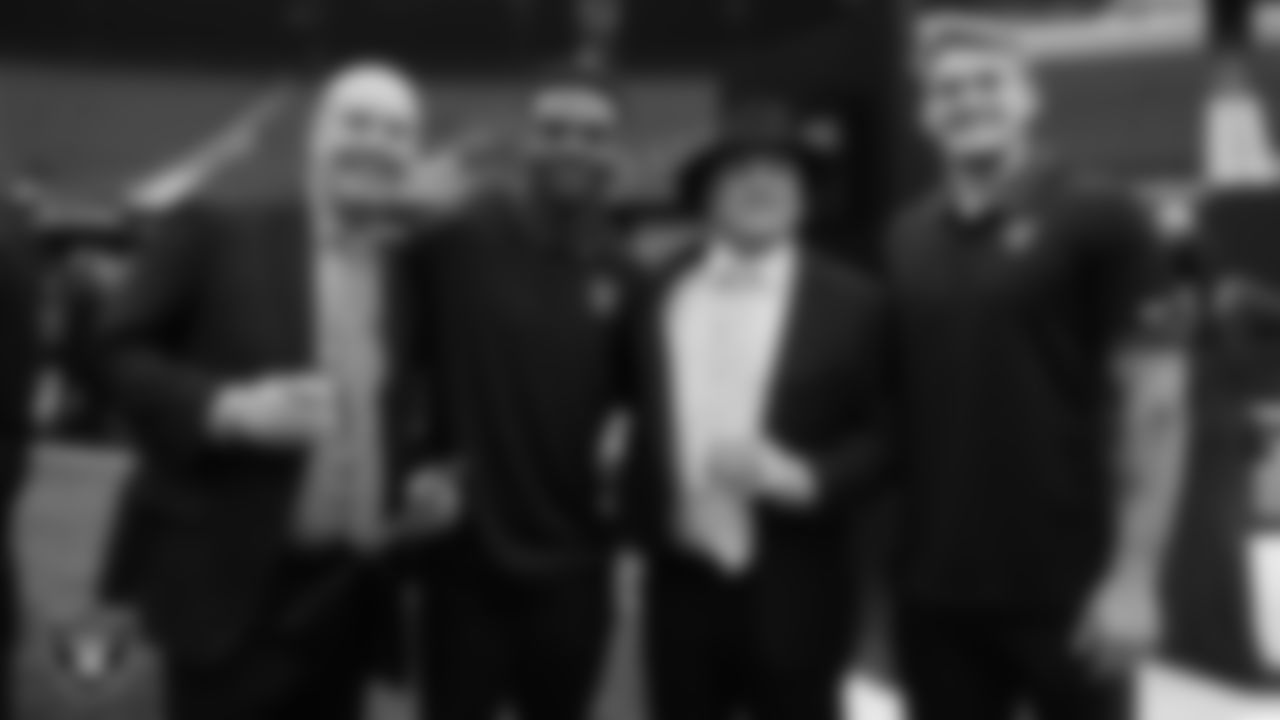 Las Vegas Raiders linebacker Jailin Walker (57) and linebacker Cody Lindenberg (55) pose for a photo with guests during the second annual Silver & Black Gala hosted by The Raiders Foundation at Allegiant Stadium.