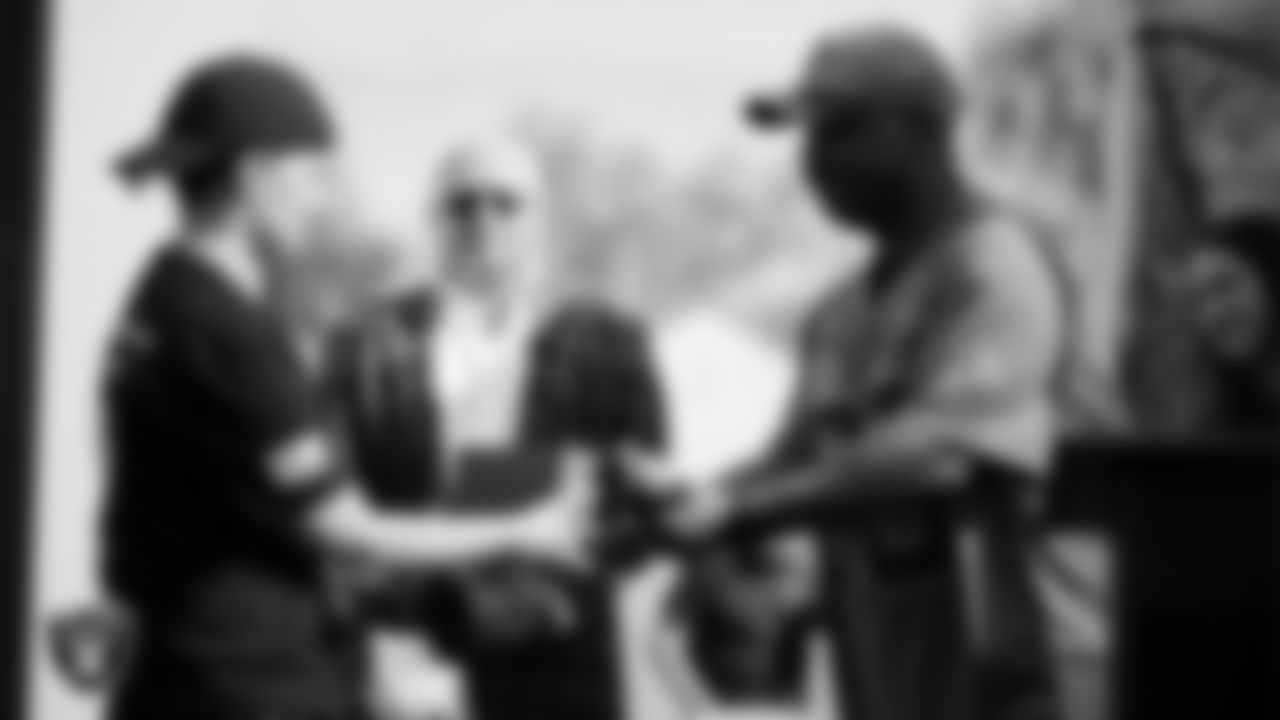 Las Vegas Raiders facilities manager and chief engineer Najja Williams presents a U.S VETS veteran with a prize from the Raiders and Fox 5 during the Veterans Tailgate in Downtown Las Vegas.