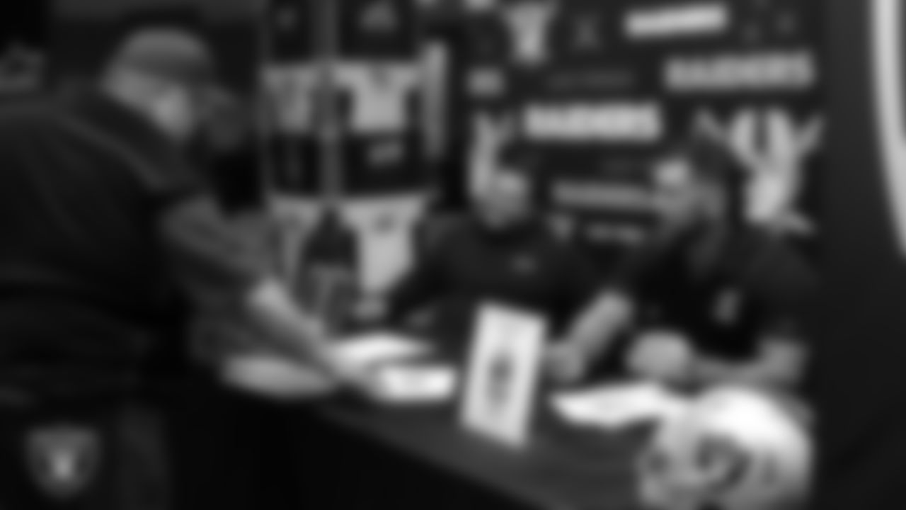 Las Vegas Raiders alumnus Robert Gallery signs an autograph for a high school football coach during a Glazier Clinic at Grand Sierra Resort.