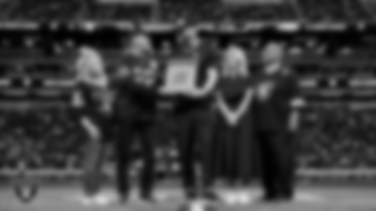 Las Vegas Raiders defensive end Maxx Crosby (98) is awarded the Commitment to Excellence Award on the field before the regular season home game against the Kansas City Chiefs at Allegiant Stadium.