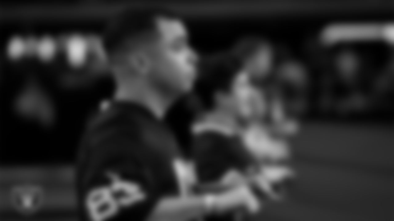 The American flag is displayed by Personal Seat License (PSL) holders on the field during the national anthem before the Las Vegas Raiders' regular season home game against the Dallas Cowboys at Allegiant Stadium.