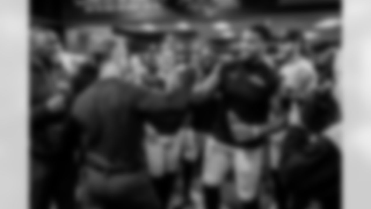 Head Coach John Harbaugh (left) & OLB Dre'Mont Jones (right)