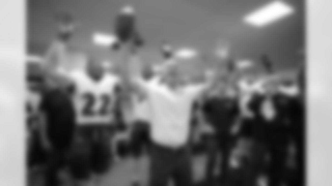 Head Coach John Harbaugh celebrates with the team.
