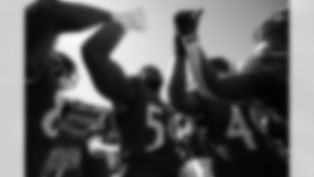 Ravens players gather in huddle