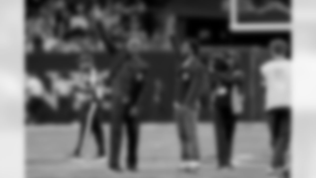 New Orleans Saints owner Gayle Benson presents Brett Maxie and Tracy Porter with their Saints Hall of Fame jackets during a ceremony on the field before the game against the Carolina Panthers on Sunday, Dec. 14, 2025 in New Orleans. (Michael DeMocker/ NFL LCC)
