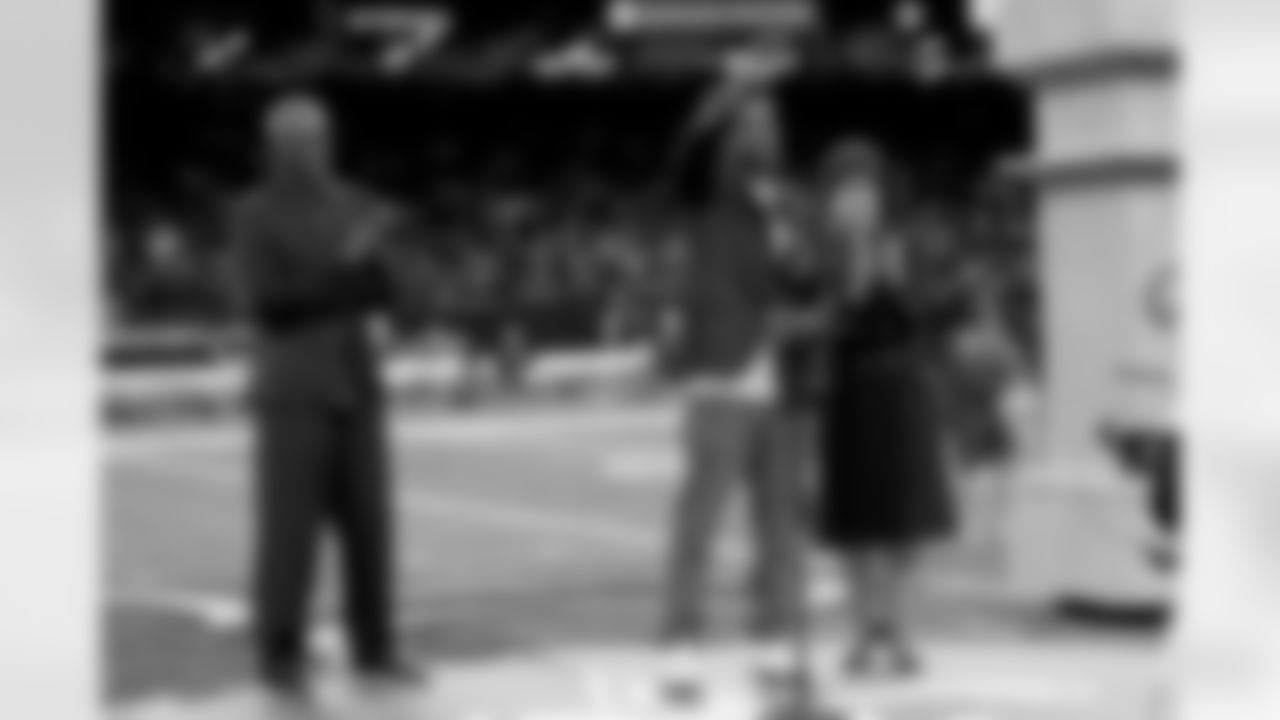 New Orleans Saints owner Gayle Benson presents Brett Maxie and Tracy Porter with their Saints Hall of Fame jackets during a ceremony on the field before the game against the Carolina Panthers on Sunday, Dec. 14, 2025 in New Orleans. (Michael DeMocker/ NFL LCC)