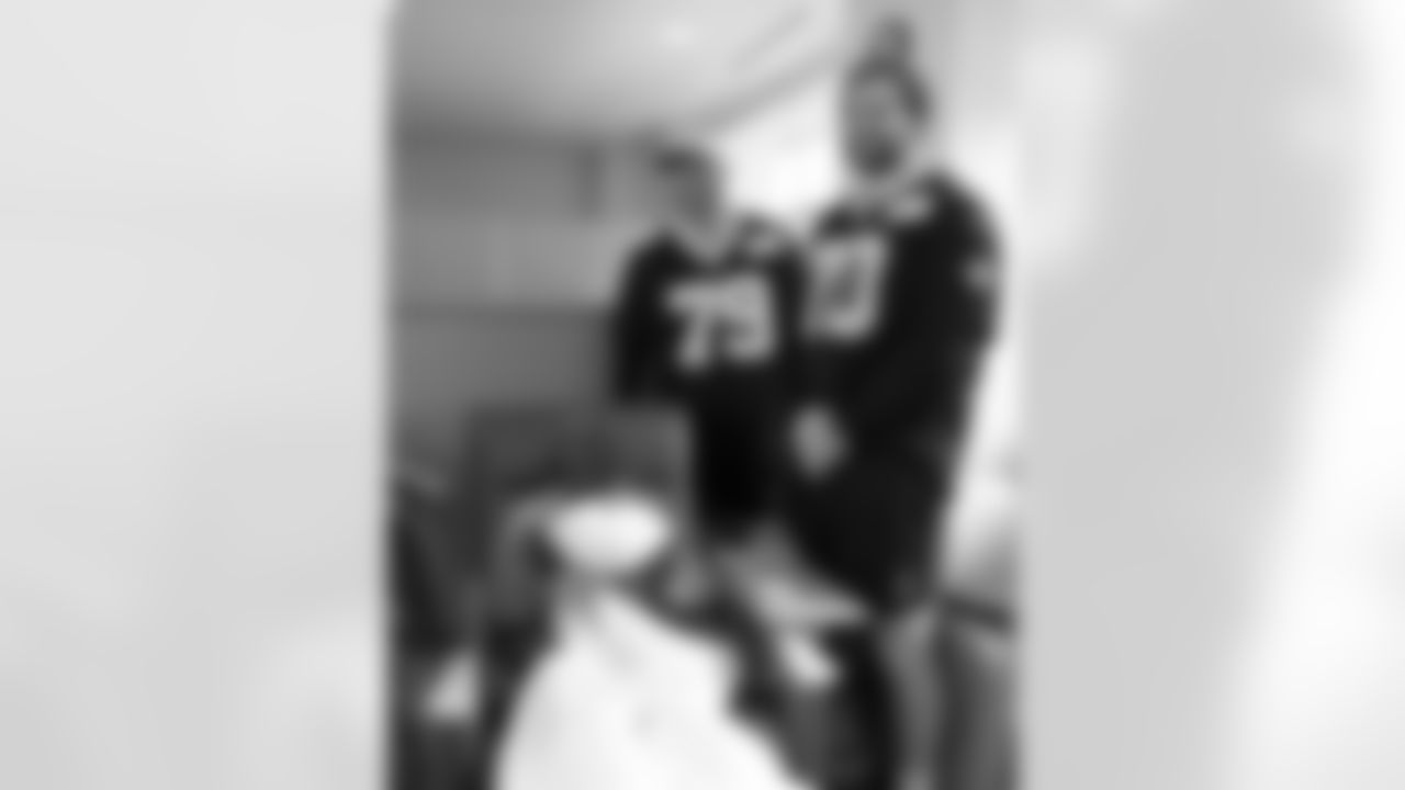 New Orleans Saints players Trevor Penning and Luke Fortner surprised patients and their families at the Gayle and Tom Benson Cancer Center on October 7, 2025 as part of the NFL's Crucial Catch month.