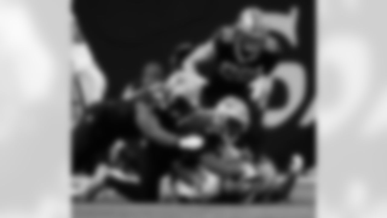 DT Nathan Shepherd (93), DE Cameron Jordan (94), and LB Demario Davis (56) tackles Alexander Mattison during the New Orleans Saints game against the Las Vegas Raiders for Week 17 of the 2024 NFL Season on Dec. 29, 2024 at Caesars Superdome.