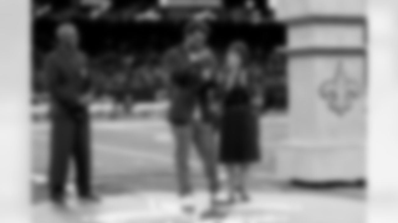 New Orleans Saints owner Gayle Benson presents Brett Maxie and Tracy Porter with their Saints Hall of Fame jackets during a ceremony on the field before the game against the Carolina Panthers on Sunday, Dec. 14, 2025 in New Orleans. (Michael DeMocker/ NFL LCC)