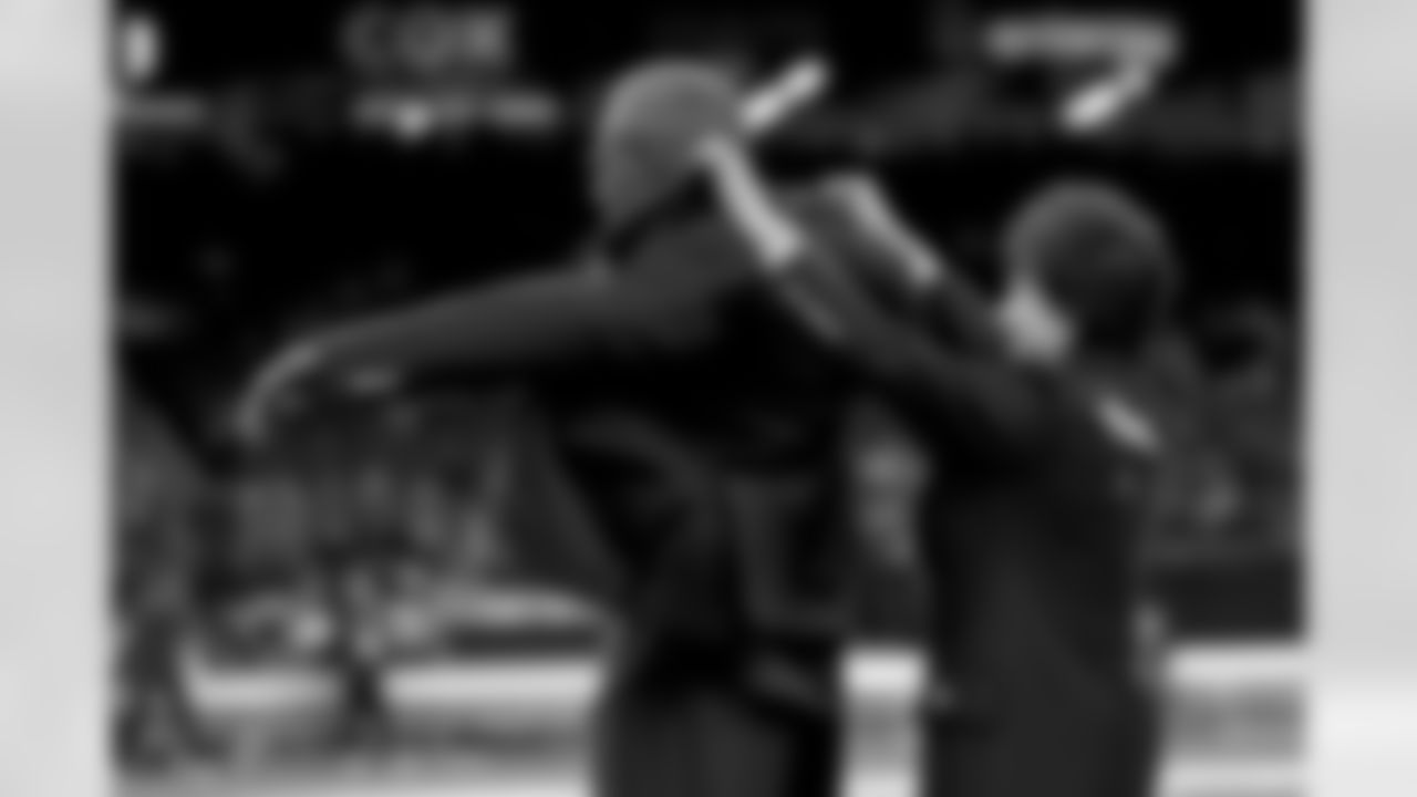 New Orleans Saints owner Gayle Benson presents Brett Maxie and Tracy Porter with their Saints Hall of Fame jackets during a ceremony on the field before the game against the Carolina Panthers on Sunday, Dec. 14, 2025 in New Orleans. (Michael DeMocker/ NFL LCC)