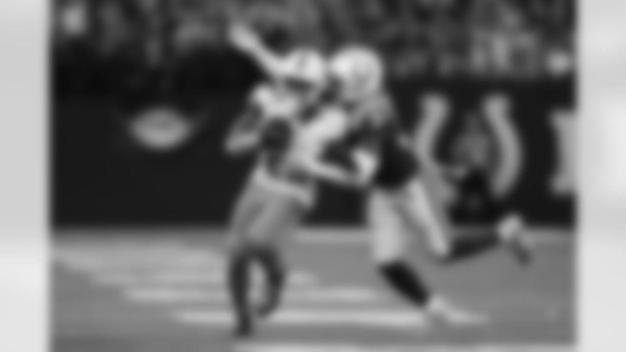 Indianapolis Colts safety Julian Blackmon (32) tackles Miami Dolphins running back Jeff Wilson Jr. (23) during an NFL football game, Sunday, Oct. 20, 2024, in Indianapolis. The Colts defeated the Dolphins 16-10.