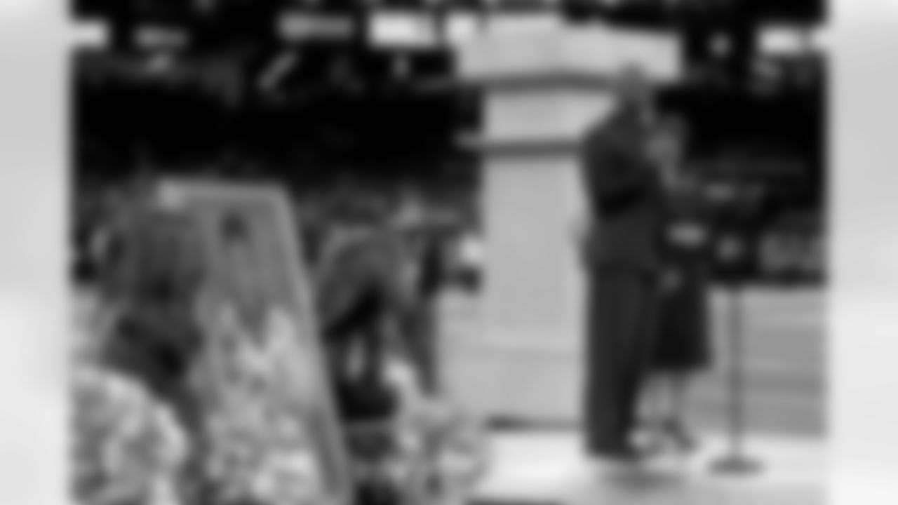 New Orleans Saints owner Gayle Benson presents Brett Maxie and Tracy Porter with their Saints Hall of Fame jackets during a ceremony on the field before the game against the Carolina Panthers on Sunday, Dec. 14, 2025 in New Orleans. (Michael DeMocker/ NFL LCC)