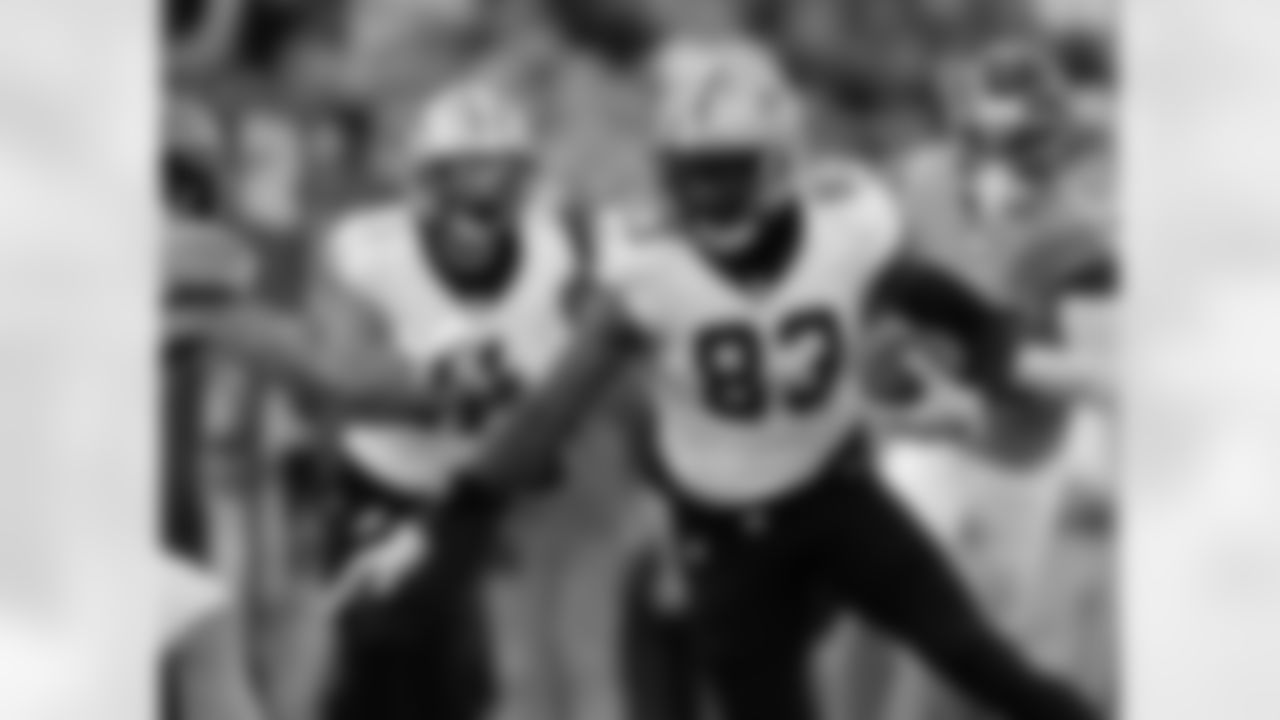 TE Juwan Johnson (83) carries the ball during the New Orleans Saints game against the Tennessee Titans for Week 17 of the 2025 NFL season on Dec. 28, 2025 at Nissan Stadium.