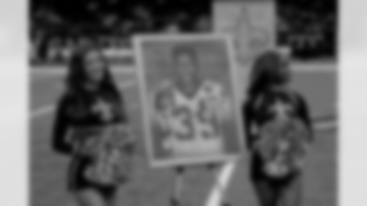 New Orleans Saints owner Gayle Benson presents Brett Maxie and Tracy Porter with their Saints Hall of Fame jackets during a ceremony on the field before the game against the Carolina Panthers on Sunday, Dec. 14, 2025 in New Orleans. (Michael DeMocker/ NFL LCC)