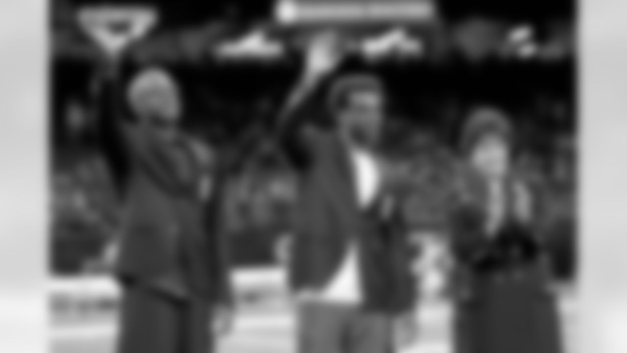 New Orleans Saints owner Gayle Benson presents Brett Maxie and Tracy Porter with their Saints Hall of Fame jackets during a ceremony on the field before the game against the Carolina Panthers on Sunday, Dec. 14, 2025 in New Orleans. (Michael DeMocker/ NFL LCC)