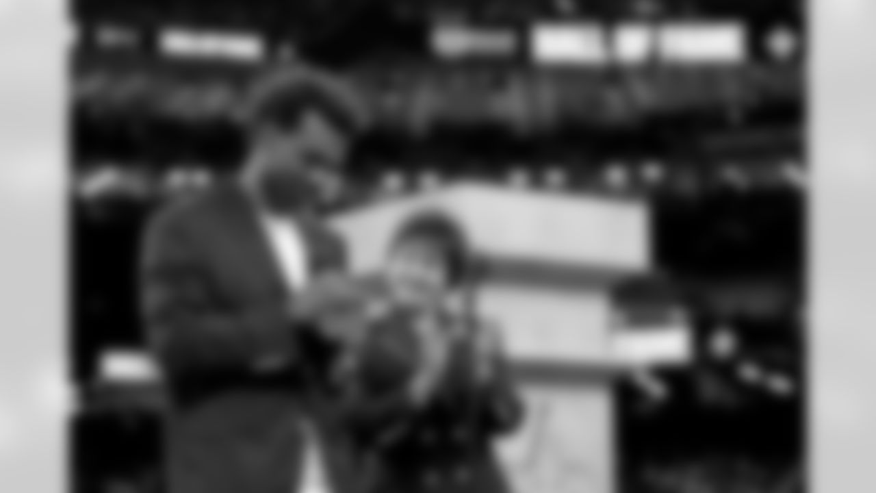 New Orleans Saints owner Gayle Benson presents Brett Maxie and Tracy Porter with their Saints Hall of Fame jackets during a ceremony on the field before the game against the Carolina Panthers on Sunday, Dec. 14, 2025 in New Orleans. (Michael DeMocker/ NFL LCC)