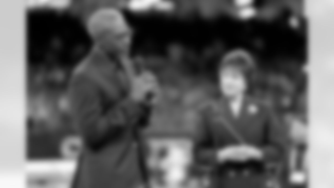 New Orleans Saints owner Gayle Benson presents Brett Maxie and Tracy Porter with their Saints Hall of Fame jackets during a ceremony on the field before the game against the Carolina Panthers on Sunday, Dec. 14, 2025 in New Orleans. (Michael DeMocker/ NFL LCC)