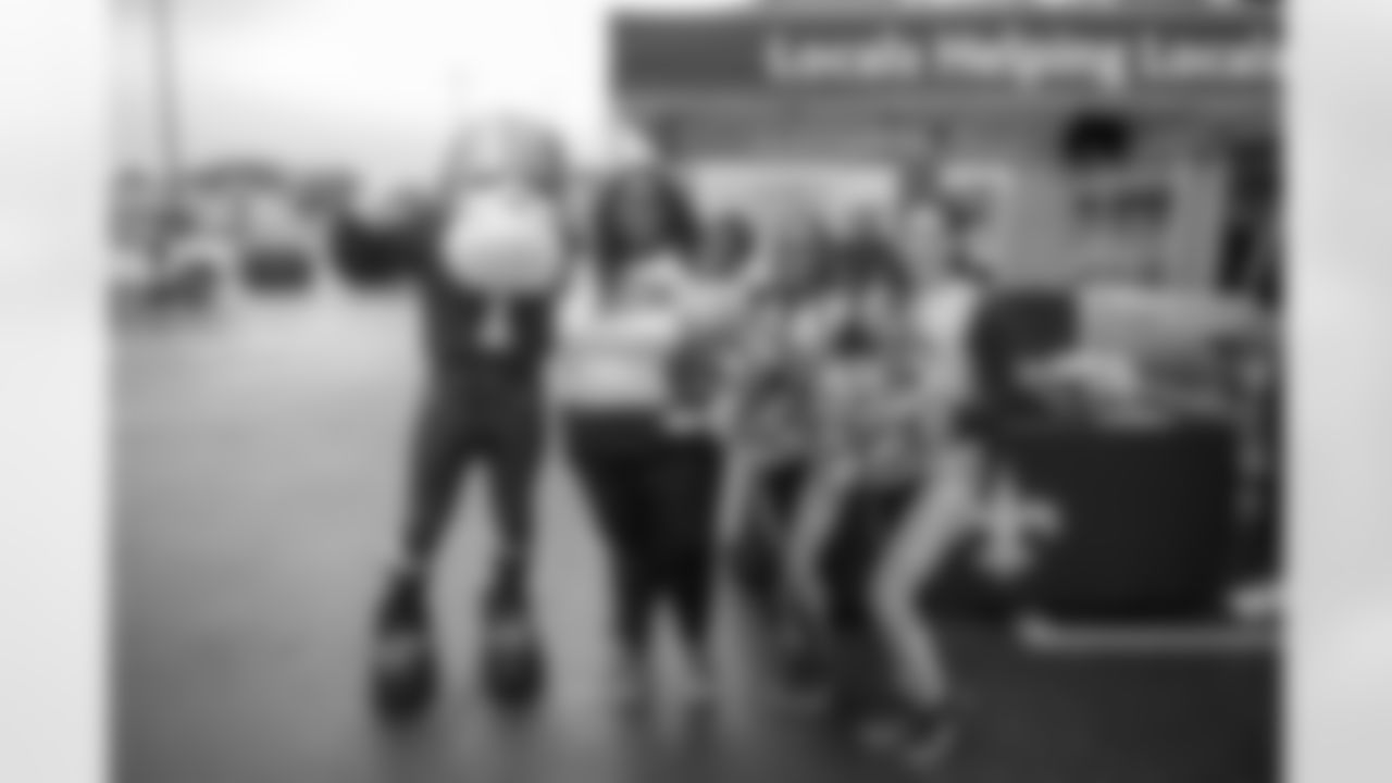 Saints legend Chris Reis appeared at the latest food drive to benefit food banks across the Gulf Coast hosted by the New Orleans Saints and Rouses Markets in Lafayette, LA on Friday, Dec. 1 along with Saints Cheer Krewe members and Sir Saint.