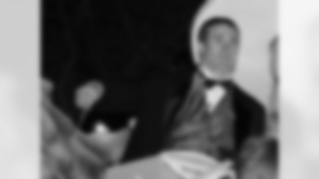 New Orleans Saints football quarterback Drew Brees throws beads as the Krewe of Bacchus rolls their Mardi Gras parade through the Uptown area of New Orleans Sunday, Feb. 18, 2007.