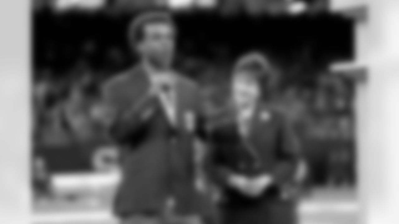 New Orleans Saints owner Gayle Benson presents Brett Maxie and Tracy Porter with their Saints Hall of Fame jackets during a ceremony on the field before the game against the Carolina Panthers on Sunday, Dec. 14, 2025 in New Orleans. (Michael DeMocker/ NFL LCC)