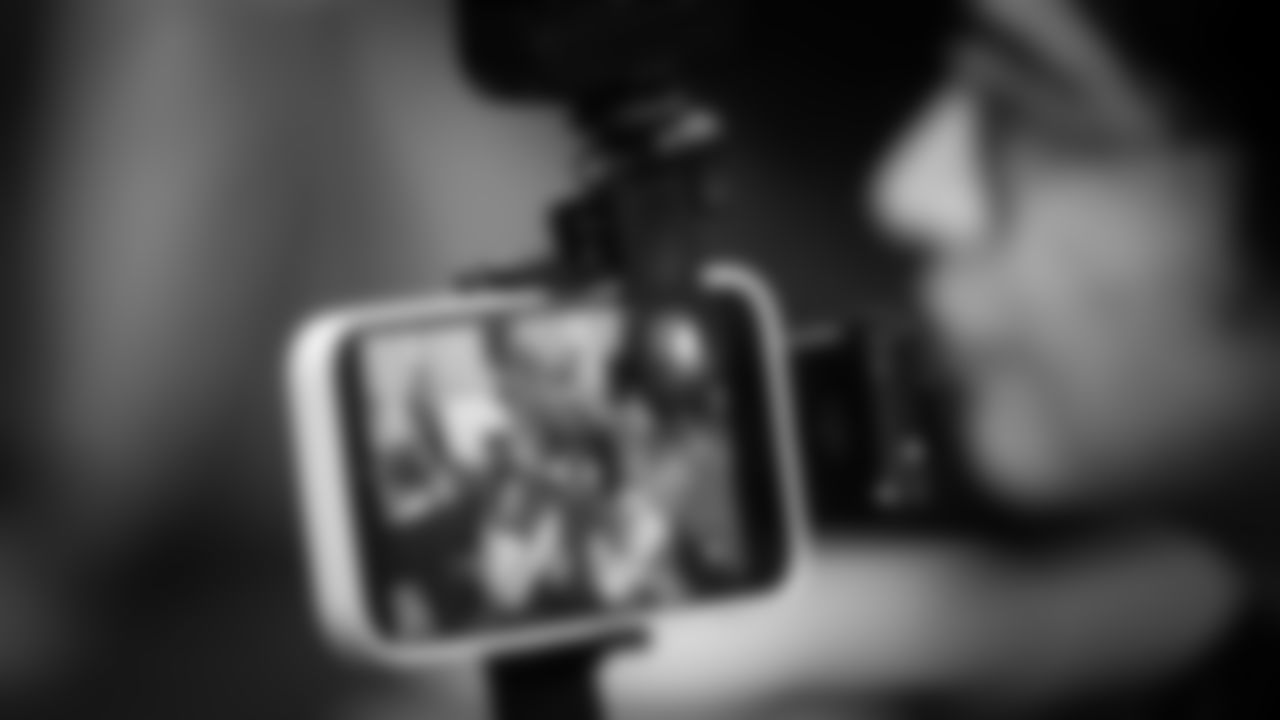 A member of the media records an interview with Seahawks running back Kenneth Walker III.