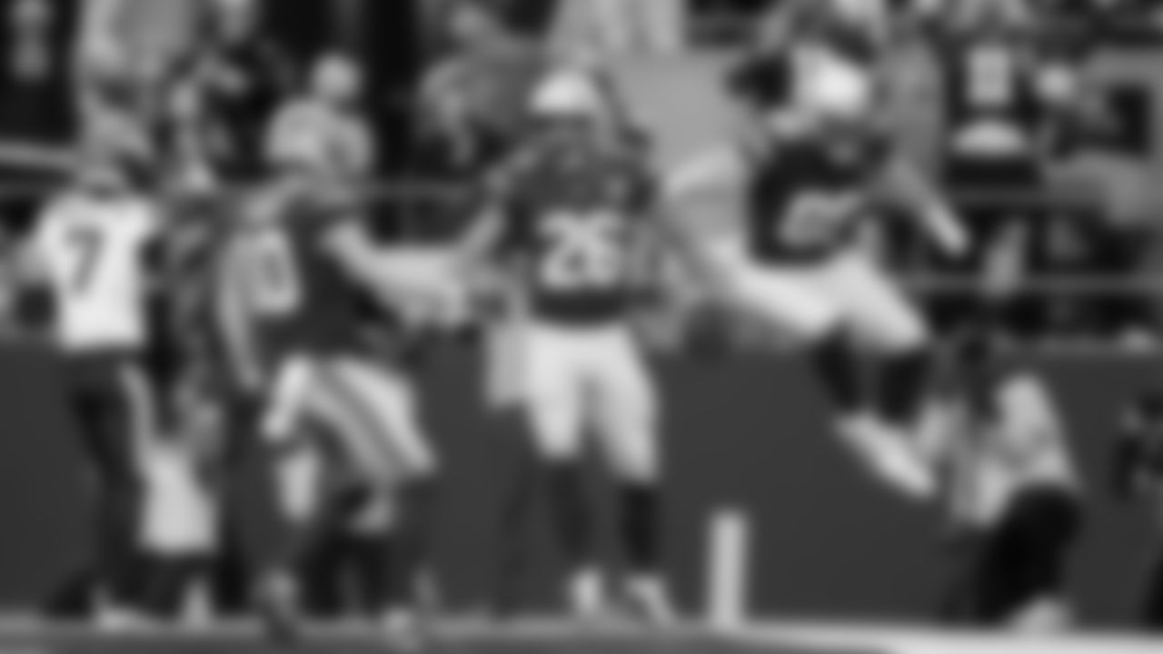 Zach Charbonnet is congratulated by Cooper Kupp and Nick Kallerup after scoring a touchdown.