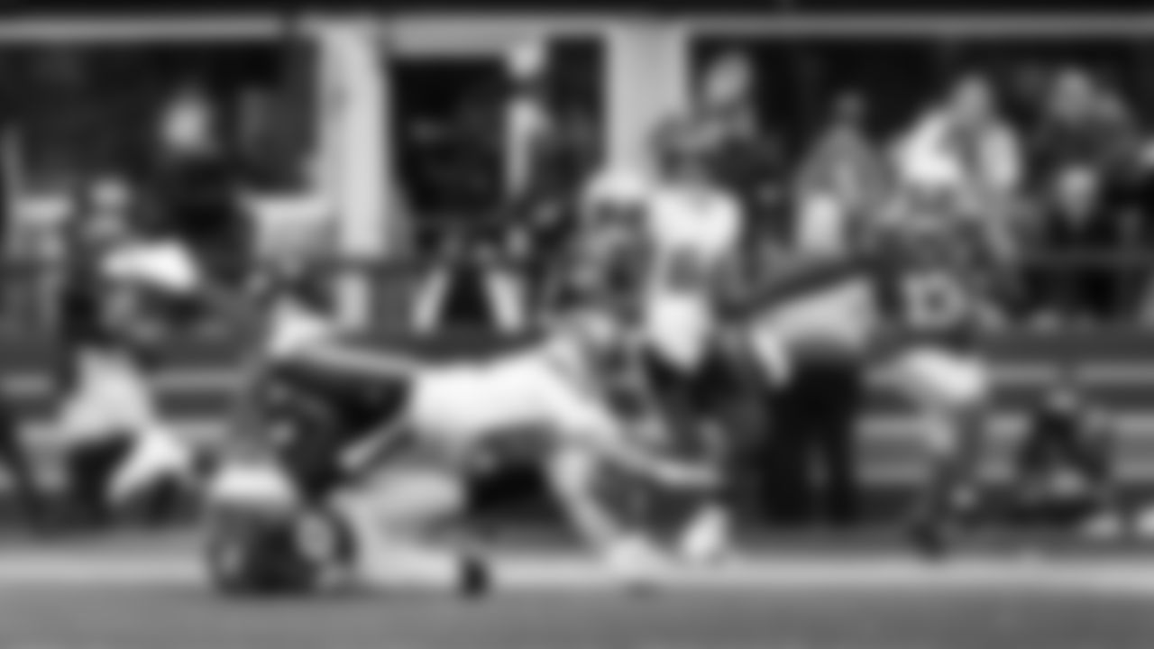 Seattle's DeMarcus Lawrence wrestles quarterback Max Brosmer to the ground as he lets go of the ball and Seahawks linebacker Ernest Jones IV heads to intercept the airborne football.