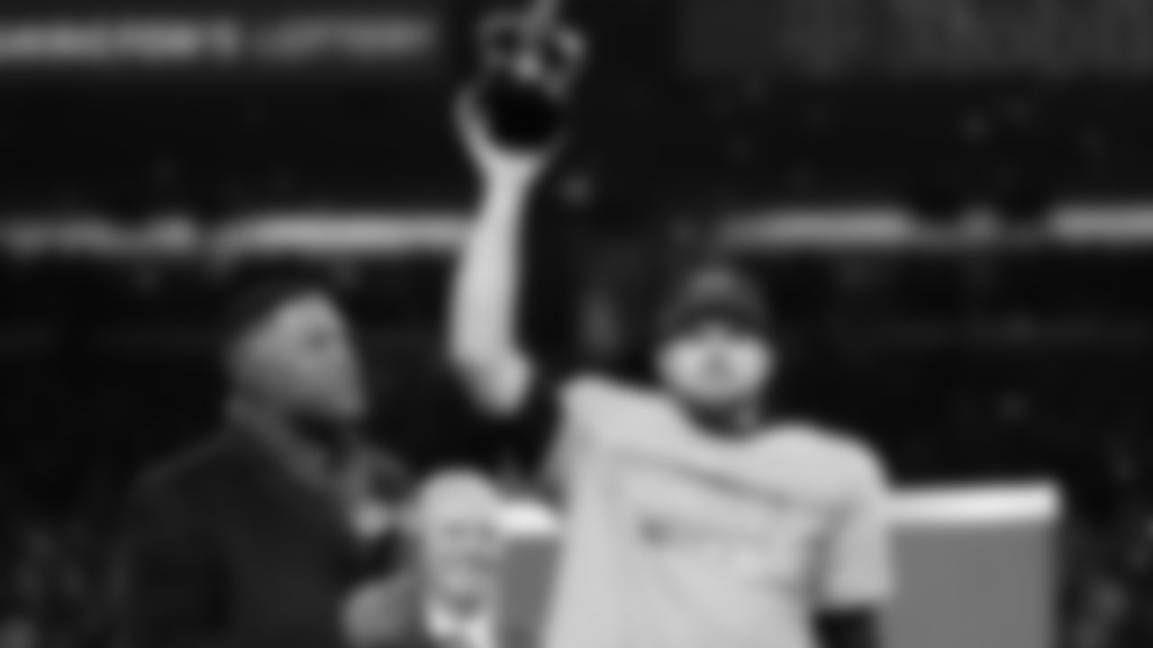 Seattle Seahawks quarterback Sam Darnold lifts the winner's trophy next to Michael Strahan, left, after a win over the Los Angeles Rams in the NFC Championship NFL football game Sunday, Jan. 25, 2026, in Seattle. (AP Photo/Godofredo A. Vásquez)