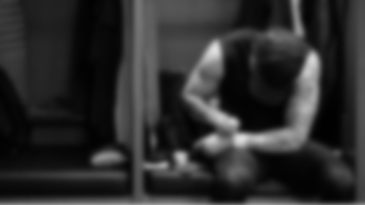 Seahawks punter Michael Dickson writes notes on his taped wrists while at his locker pregame.