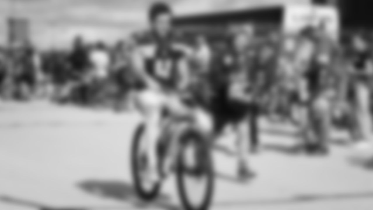 Seahawks punter Michael Dickson (4) rides a bike on their way to practice on August 21, 2025 in Green Bay, Wisconsin.
