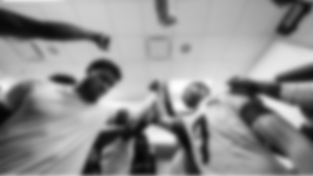 Seattle's Uchenna Nwosu brings the Seahawks up as they huddle in the locker room after the game.