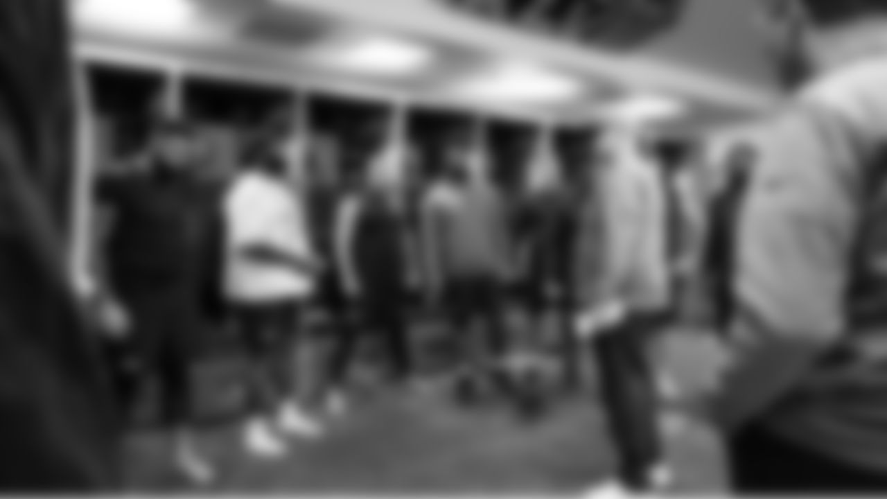 Seahawks offensive line coach John Benton talks with his position group before early warmups.