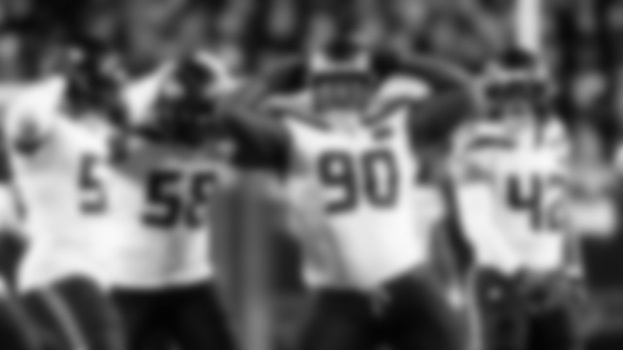 Seattle's Jarran Reed celebrates a sack with teammates Boye Mafe,  Derick Hall, as Drake Thomas looks on.