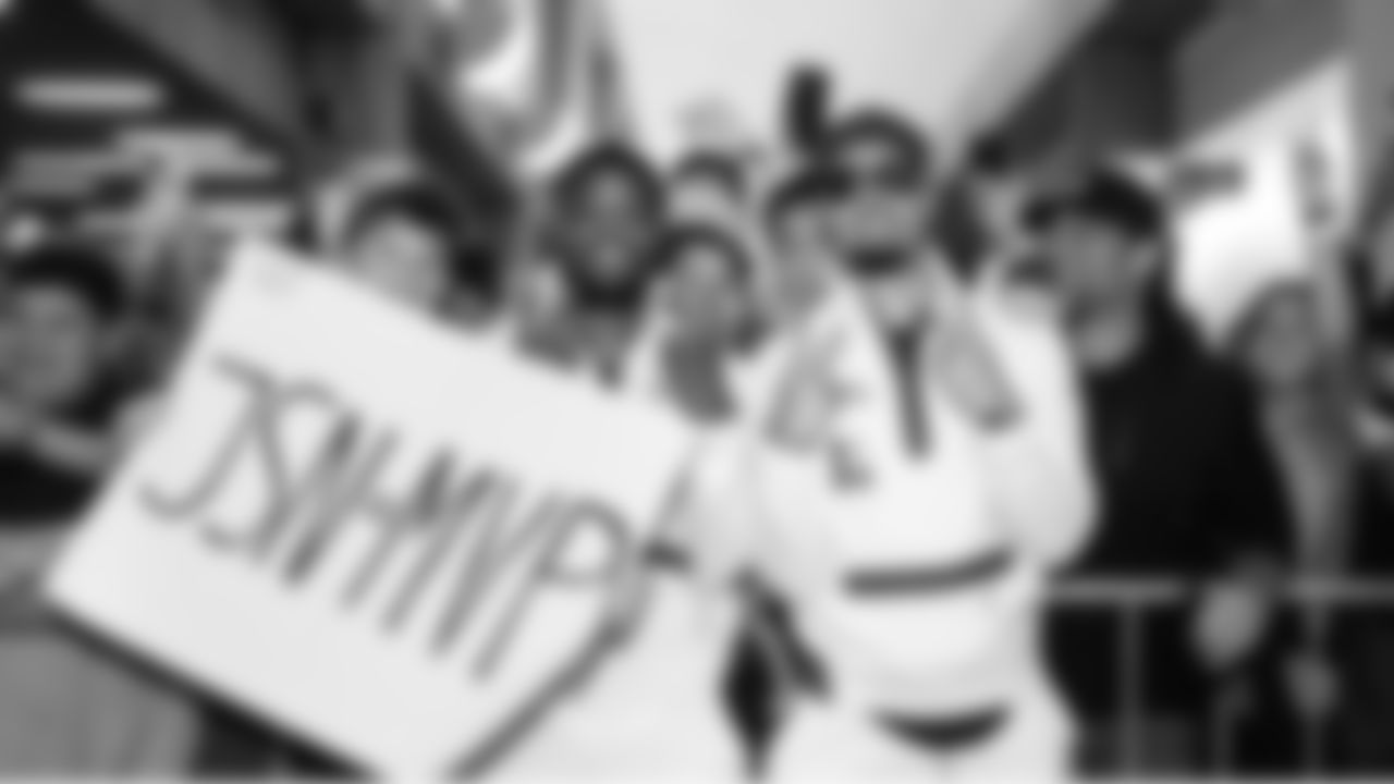 Devon Witherspoon and Jaxon Smith-Njigba pose with fans at Super Bowl Opening Night.